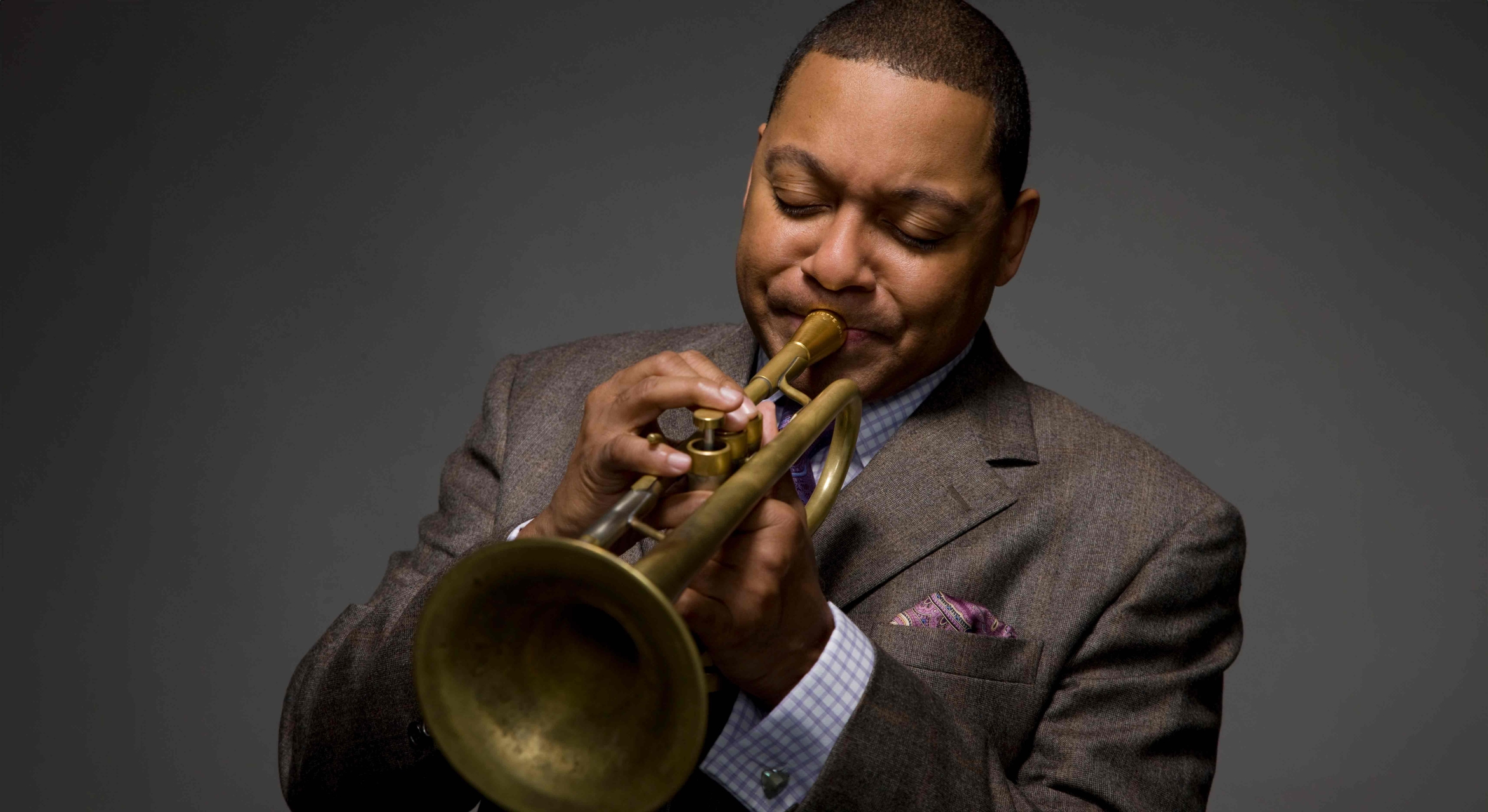 Black man playing wind instrument