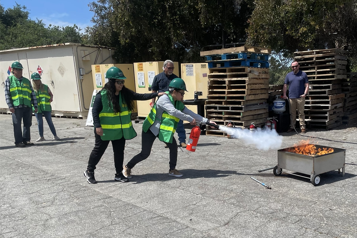 Two CERT trainees put out a fire