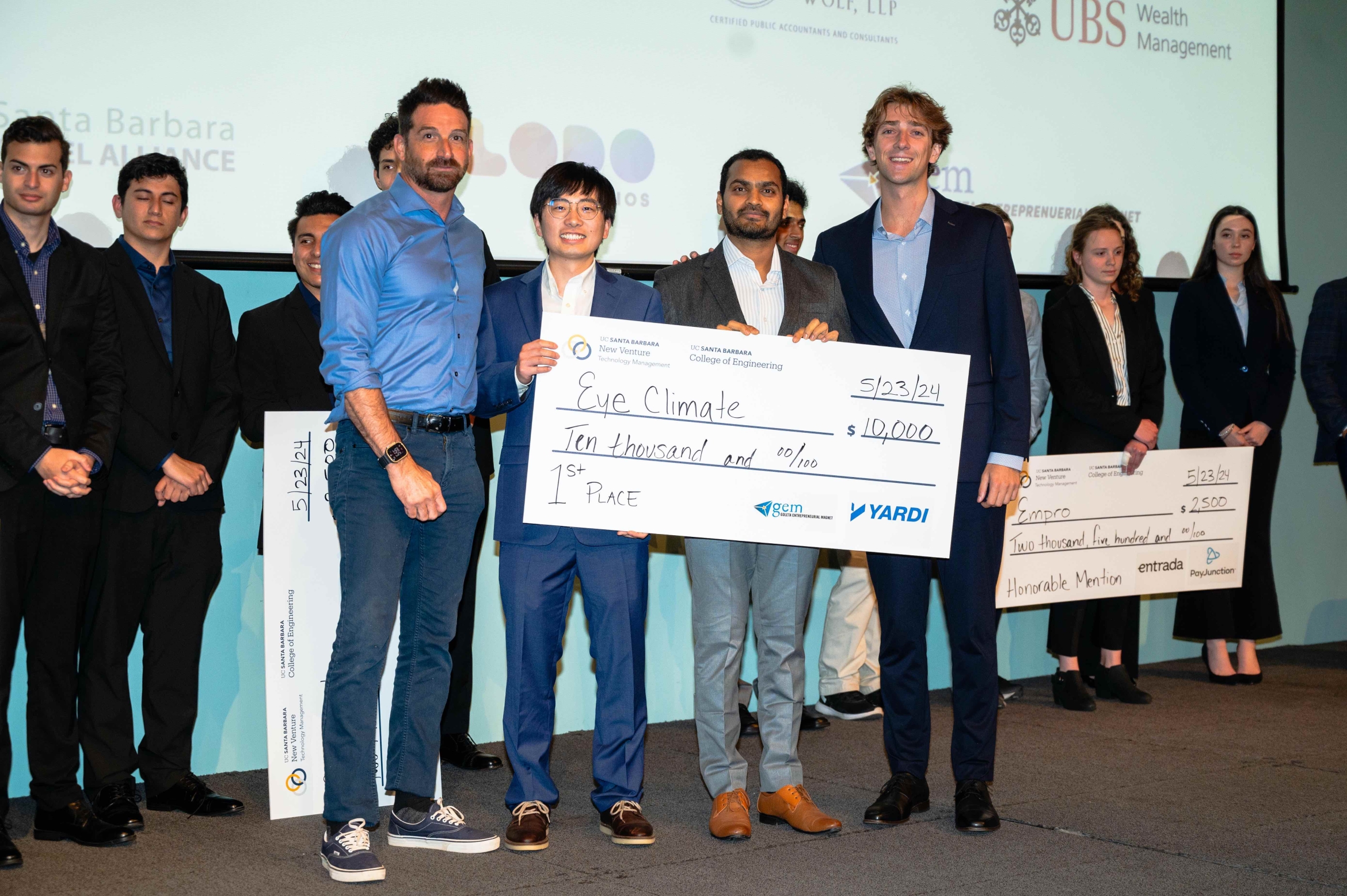 winners of business plan competition with large first-place check