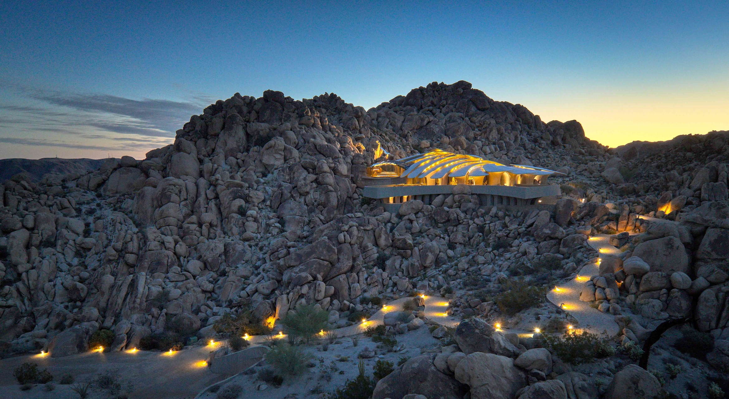 house nestled in rocks in night landscape 