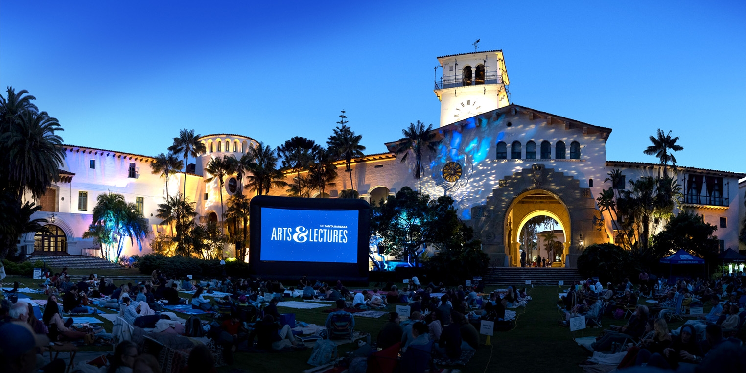 View of Santa Barbara County Courthouse at night, fronted by a projection screen