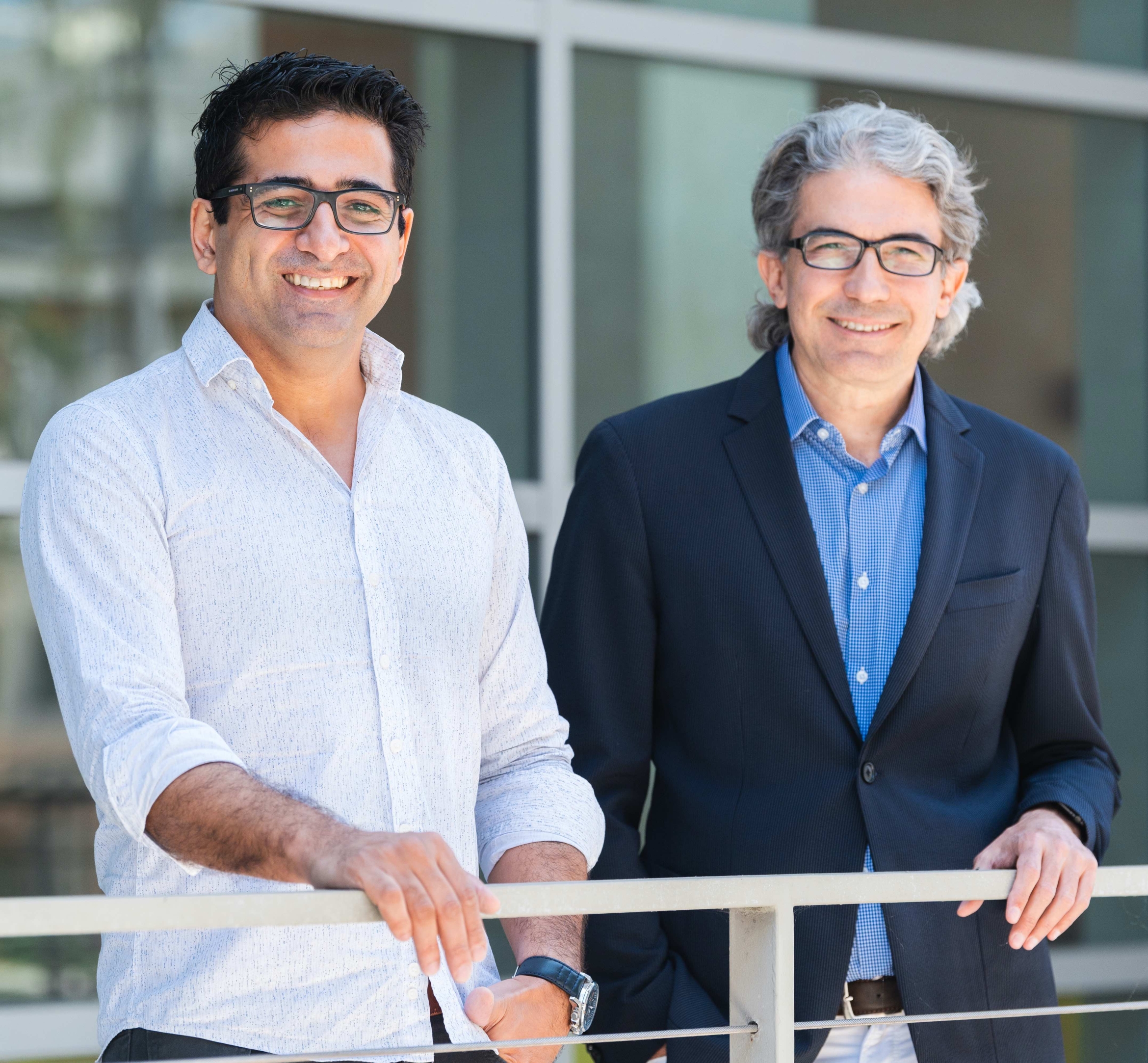 two professors standing outside a building