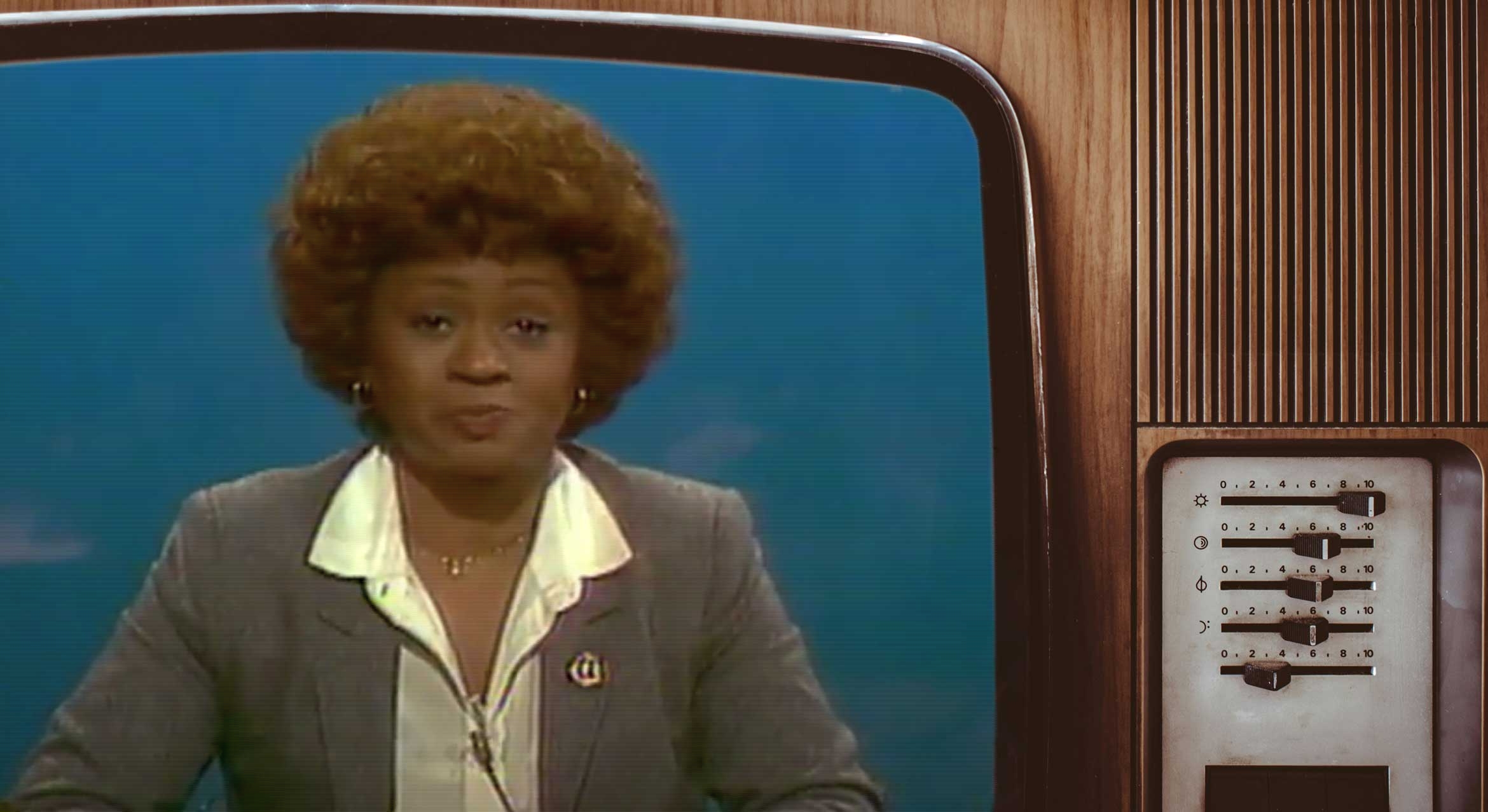 Black female news anchor on tube television set.