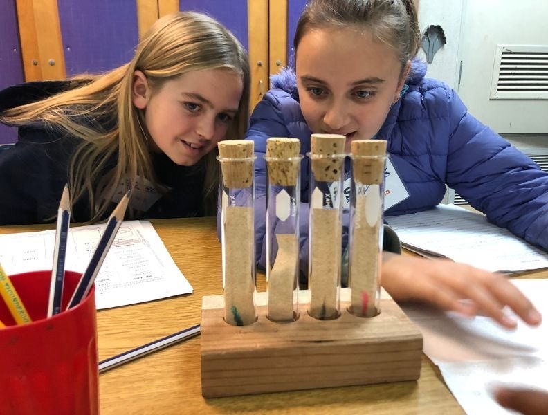 Two 5th graders experiment with chromatography using pen ink.