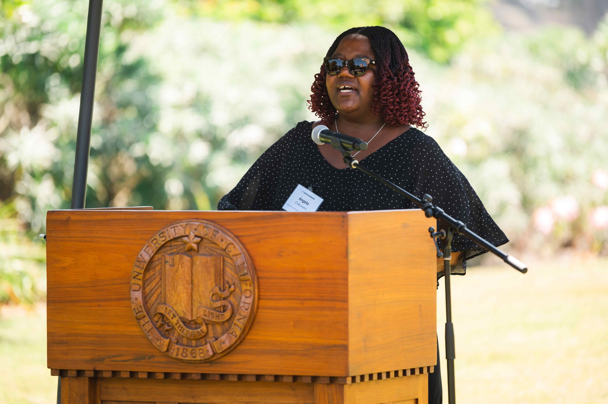 Black woman at podium with insignia