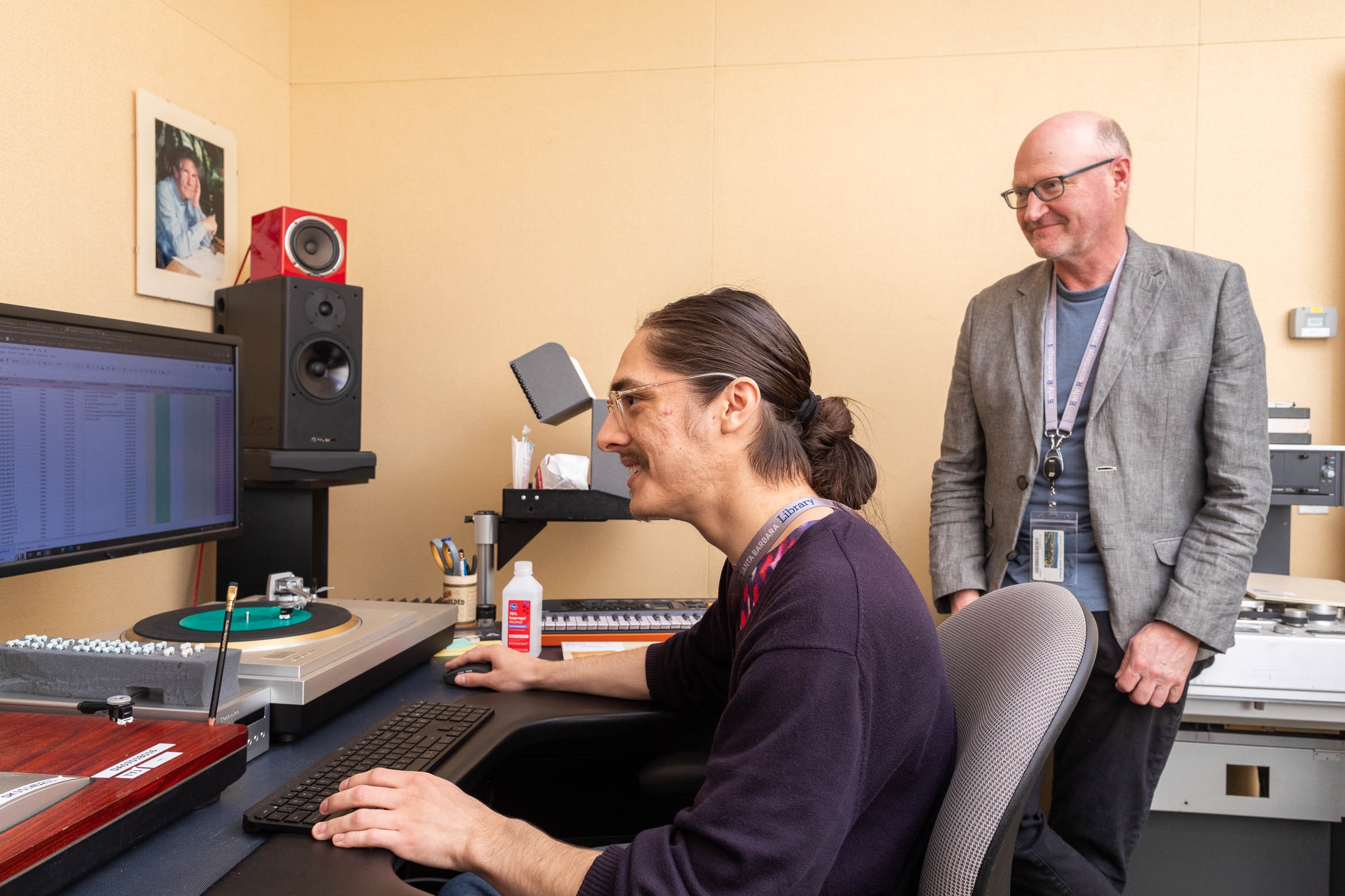 technicians in an audio lab digitizing a dictaphone disc