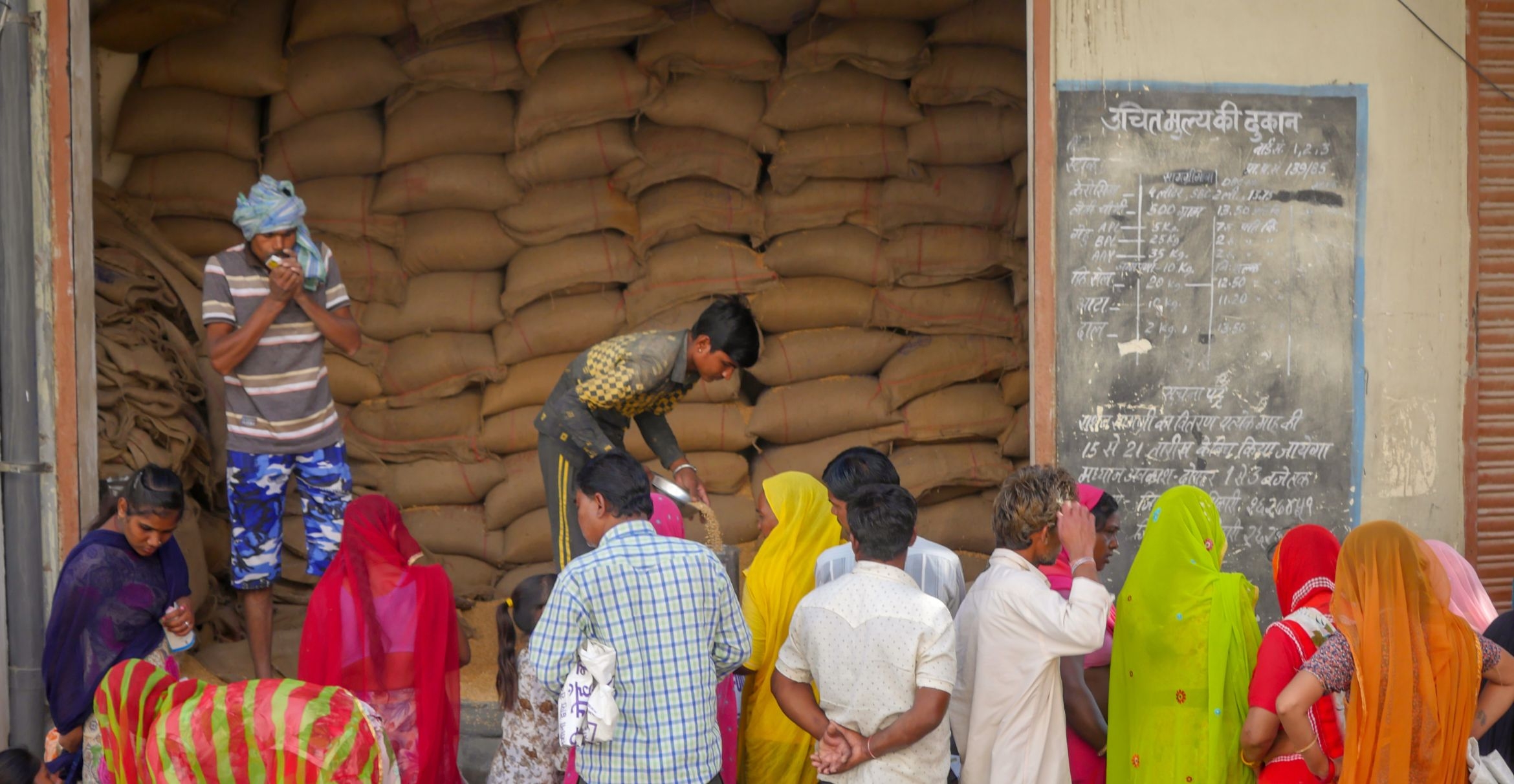 People gather outside a public distribution shop in Rajasthan, India.