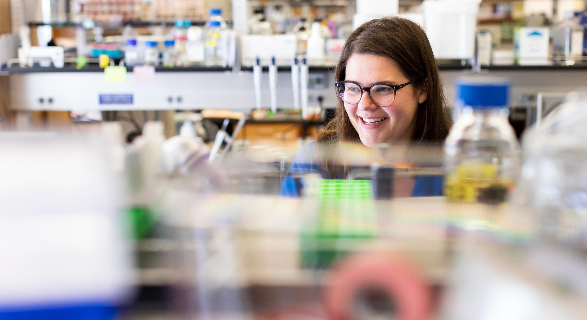 Meghan Morrissey behind lab equipment.