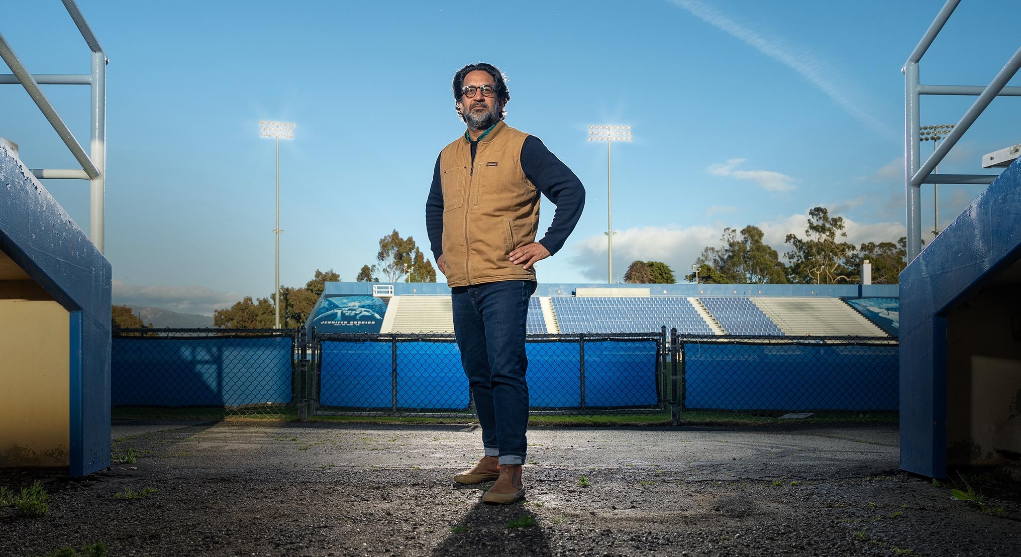 man of East Asian descent in stadium with dramatic light