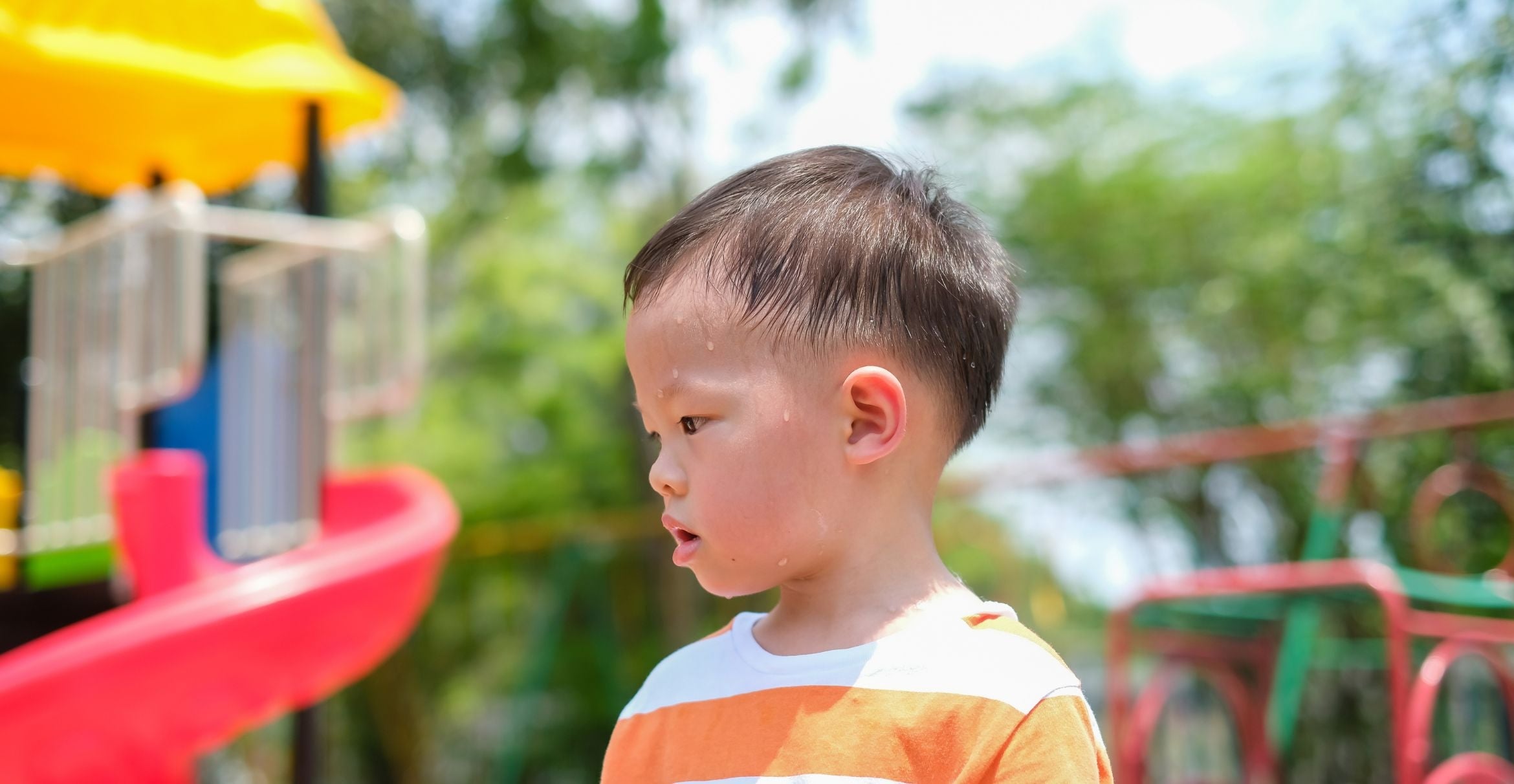 A sweaty child on a playground.