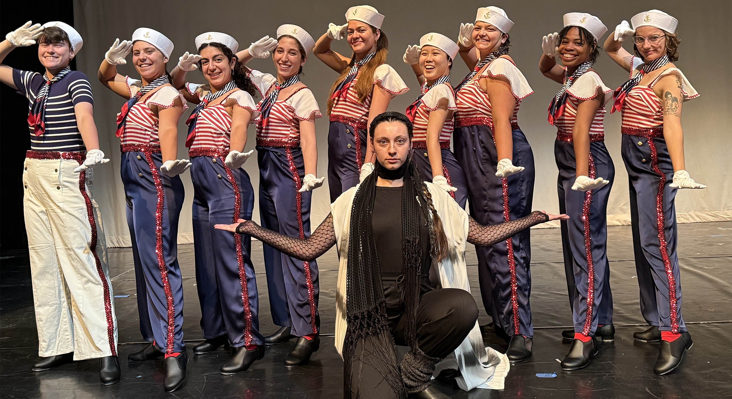 Women dressed as sailors posed on a stage