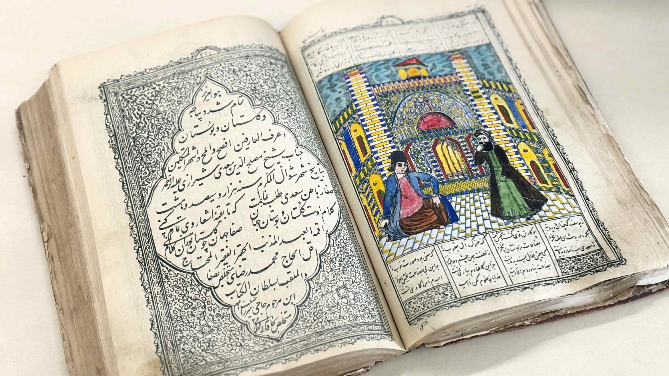 open book with Persian writing and drawing