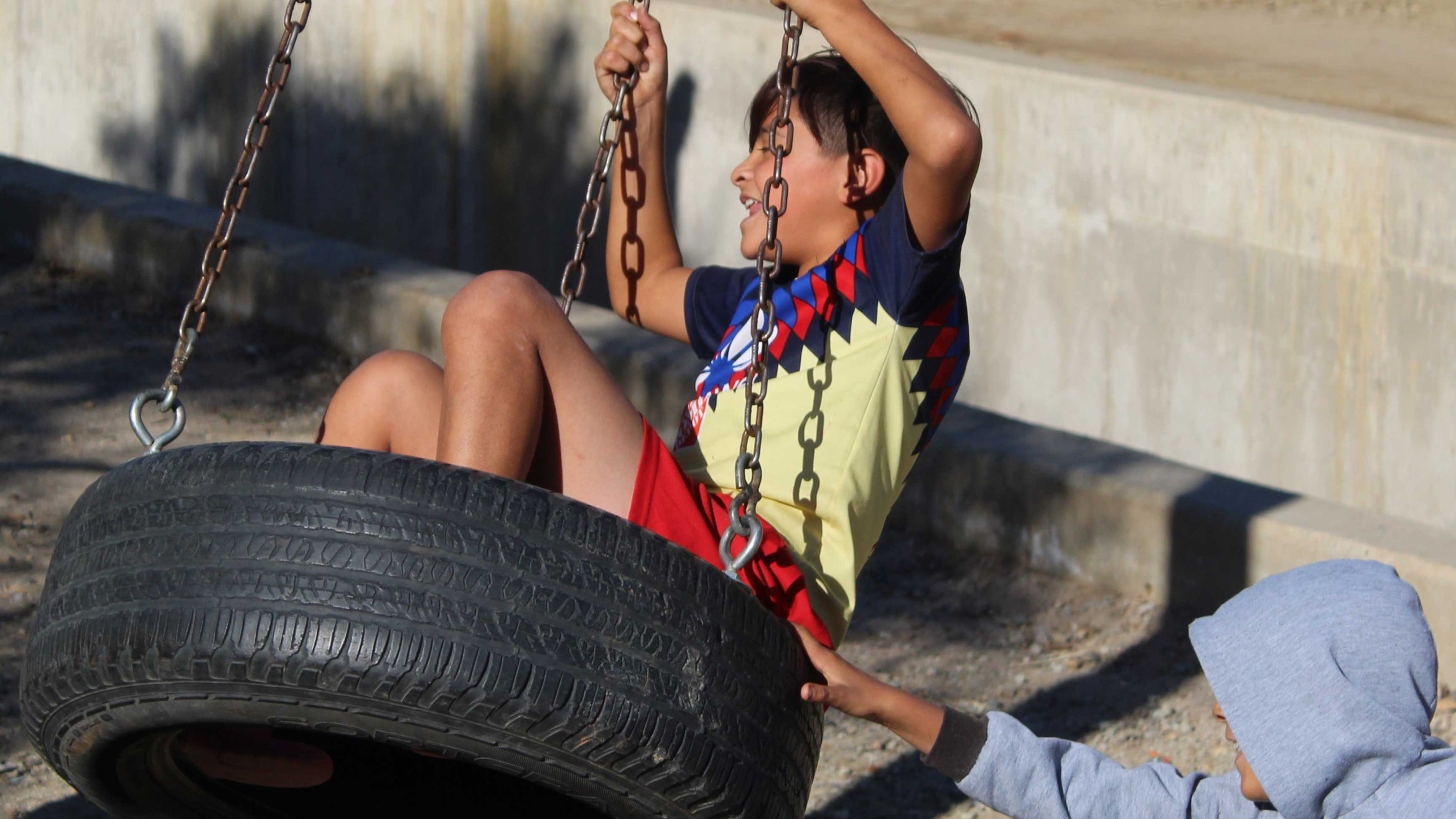 child swings in tire