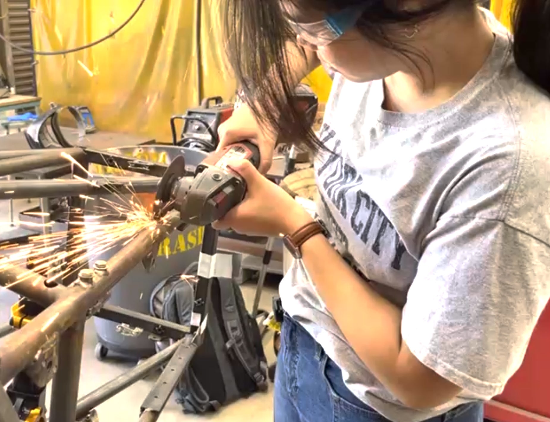 photo of team member working on electric F1 racer chassis