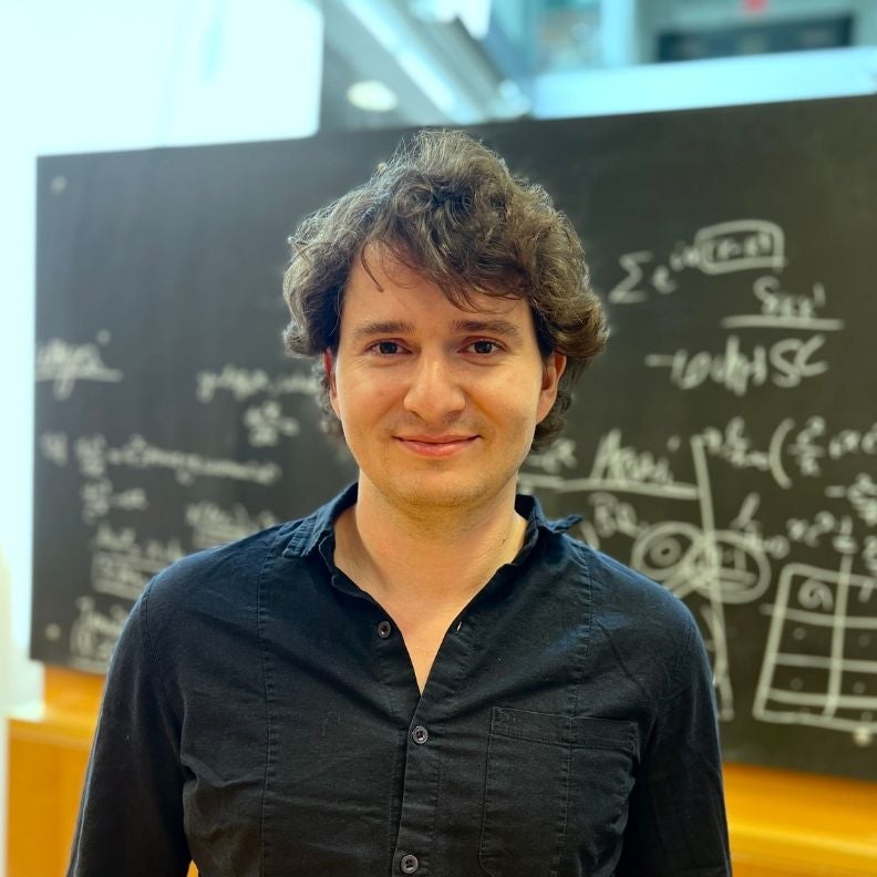 Bruno Scheihing-Hitschfeld in front of a blackboard with scientific formulae.