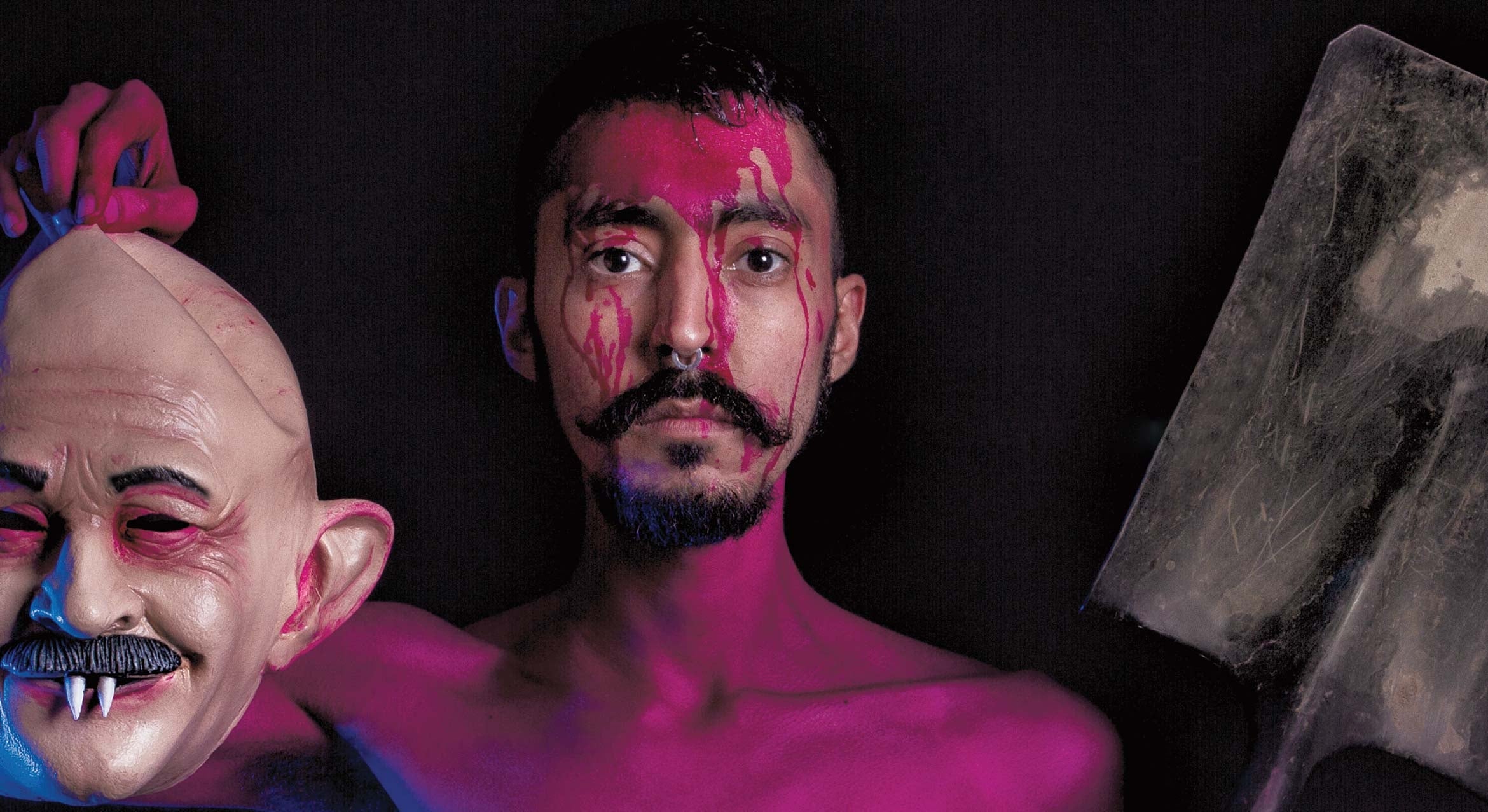 bloody face man holding mask and shovel