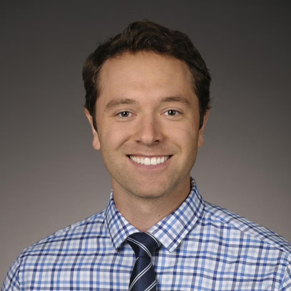 Sean Denny in a collared shirt and tie.