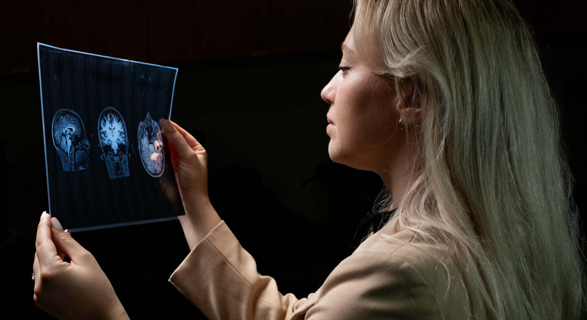 graduate student Kylie Falcione looks at brain scans