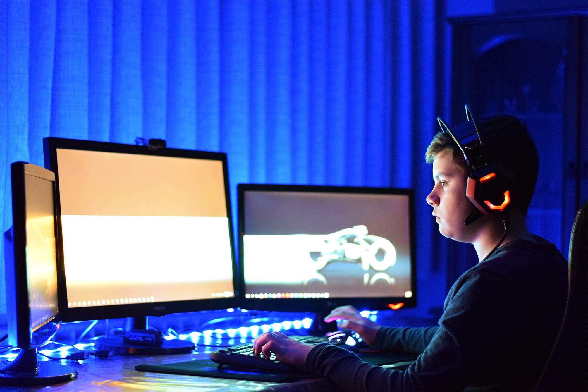 color photograph of a boy playing a computer video game in 2018