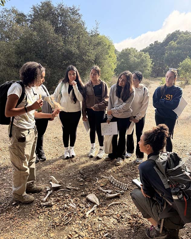 environmental education students identifying bones along a nature trail