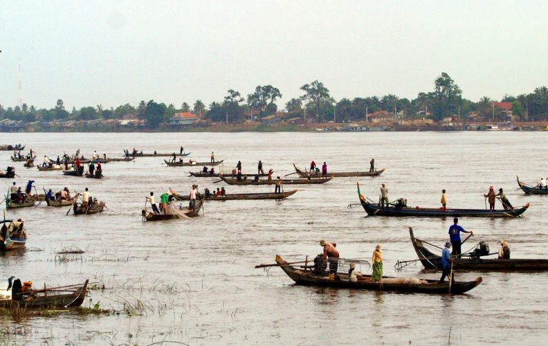 About two dozen fishing boats ply the waters of the Tonle Sap Lake, a major tributary of the Mekong.