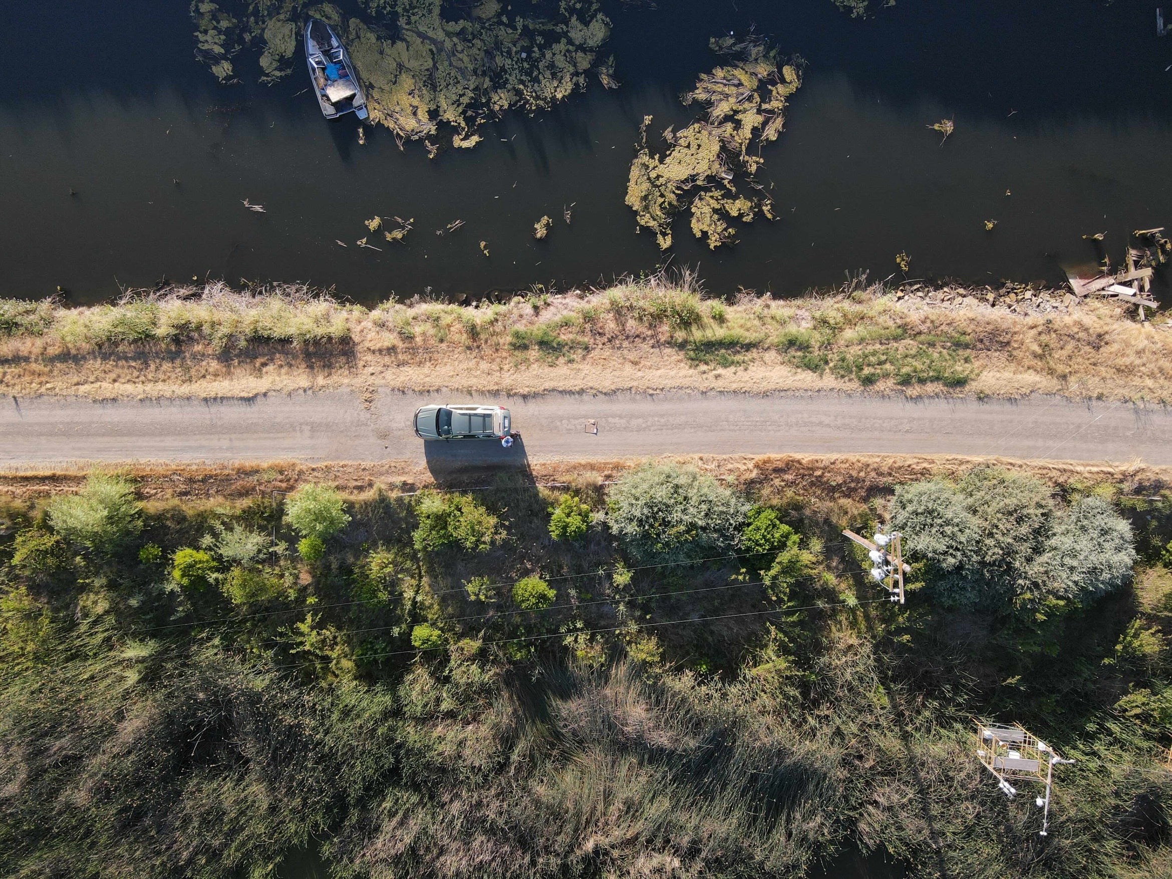 aerial photo of restored wetlands (below) vs unrestored wetlands (above)