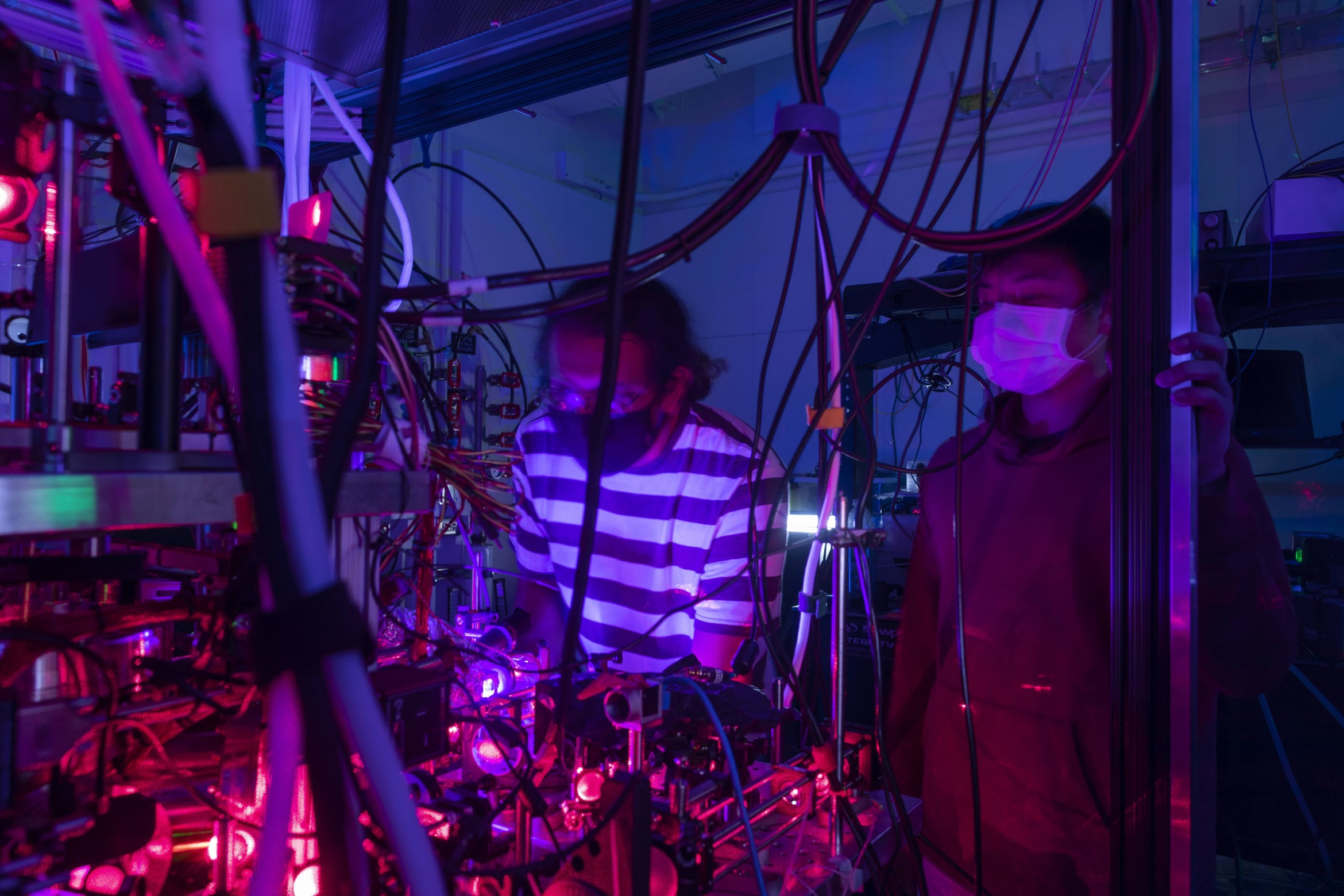 researchers at an optical table