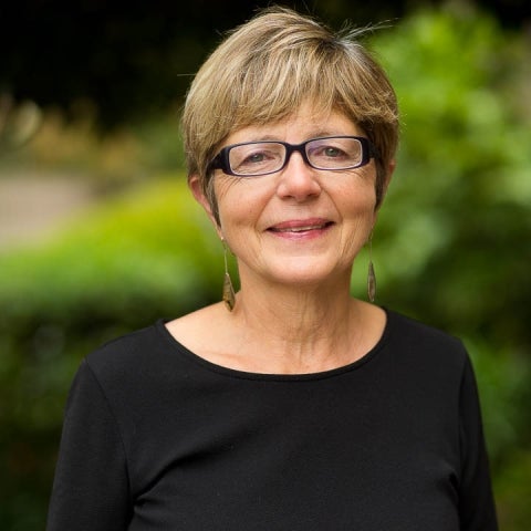 M. Cristina Marchetti in a black top and glasses