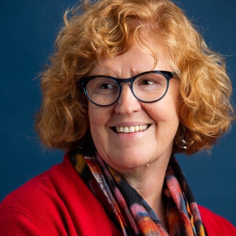 Ann Marie Plane in a red top and scarf