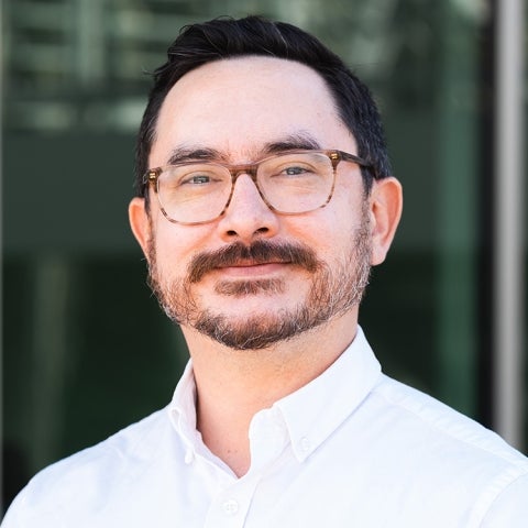 Alexander Cho wears a white collared shirt