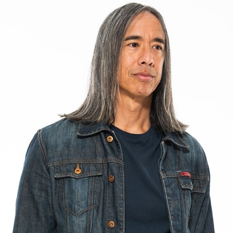 Kip Fulbeck wears a dark shirt and a denim jacket