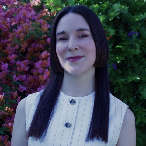 Madeleine Gross wears a button up white top
