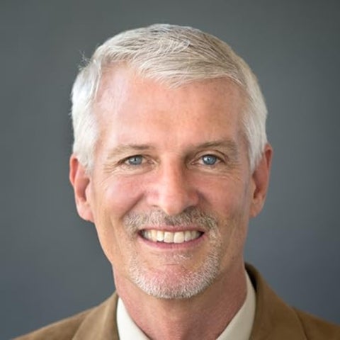 James B. Rawlings wears a tan suit