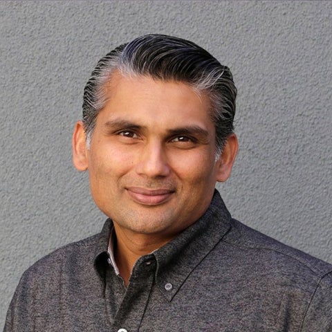 Luke Theogarajan wears a dark gray collared shirt