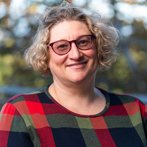 Jenni Sorkin wears a red and black checkered dress