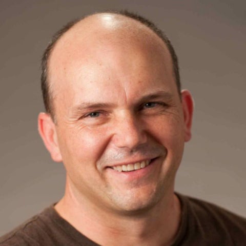 Christopher Hayes wears a brown shirt