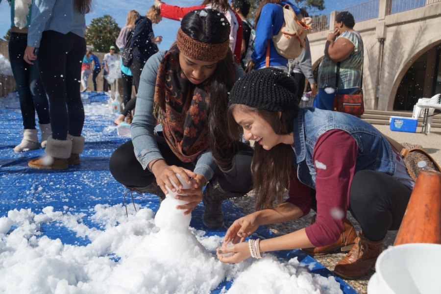 two students making a snowman